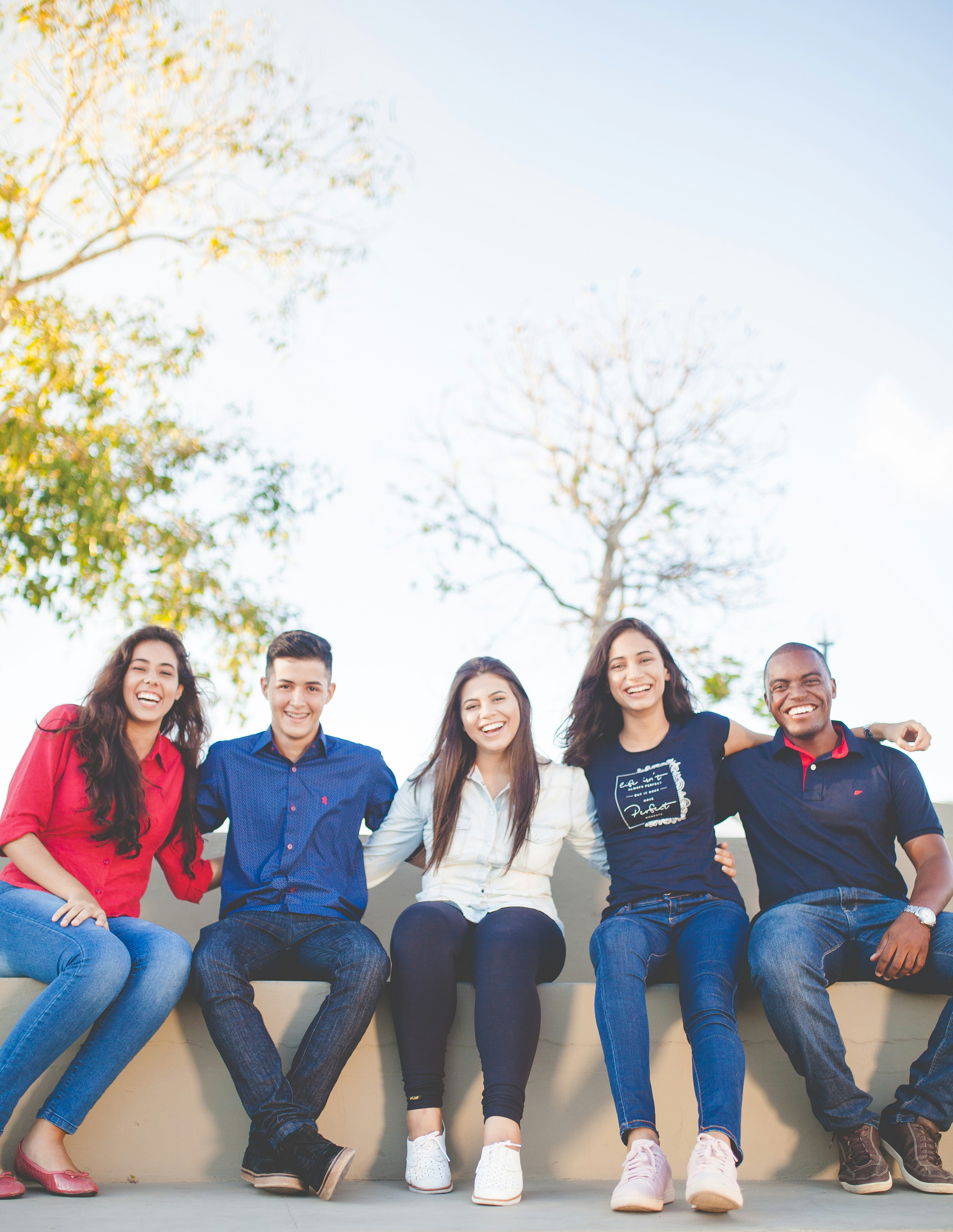 Diverse group of young people smiling together outdoors